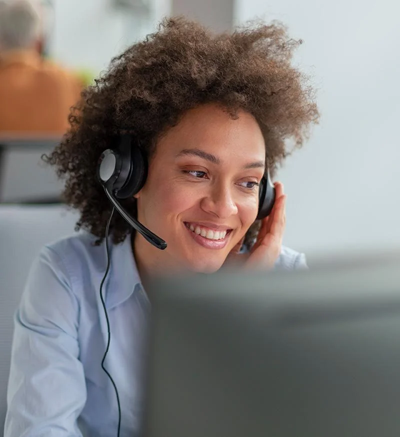 Customer support representative wearing a headset while assisting a customer